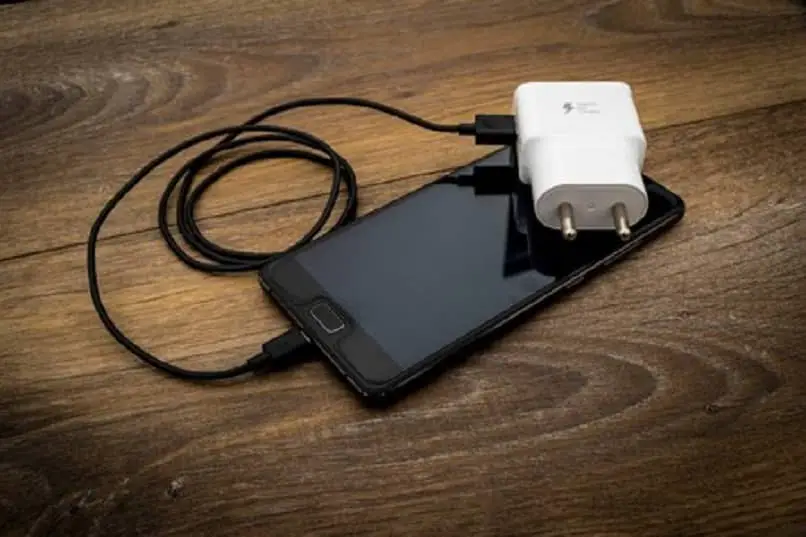 dispositivo mobile con cavo USB e adattatore bianco 